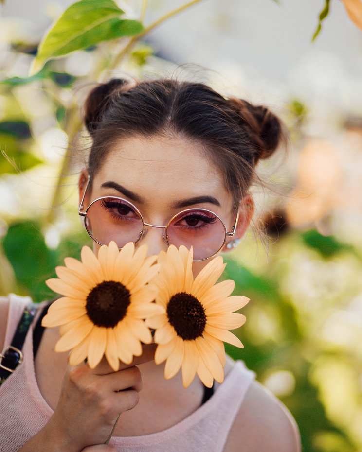Woman Holding Two Sunflowers