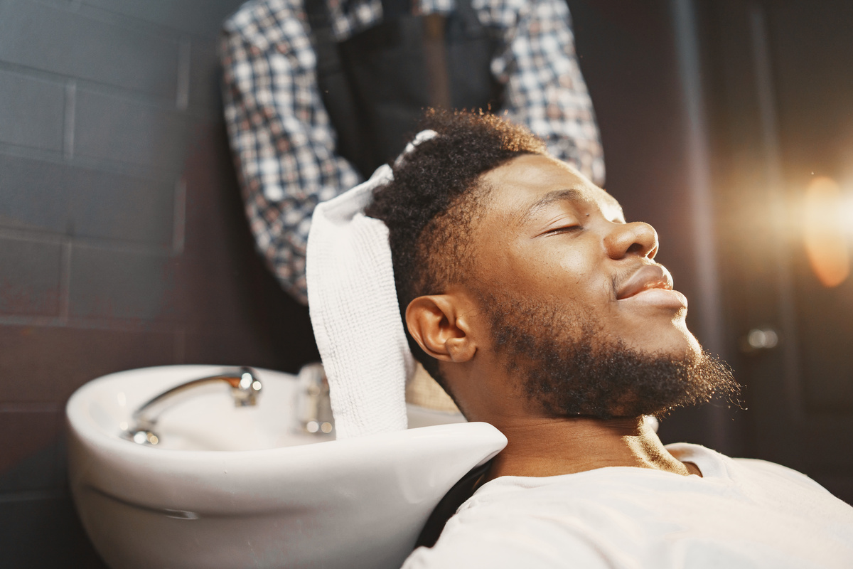 Man Getting His Hair Washed in a Barber Shop 